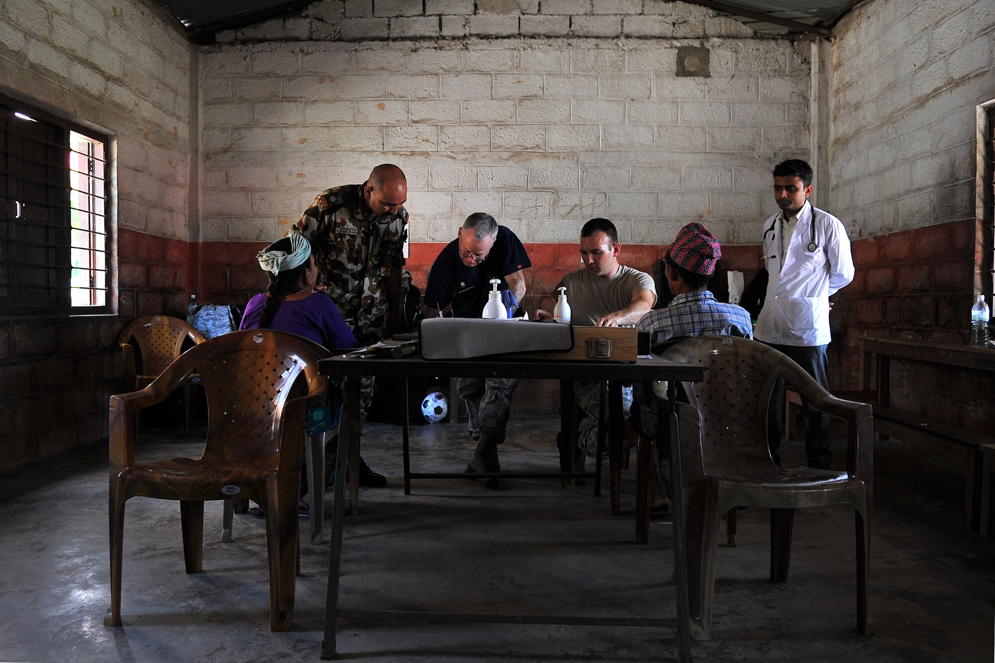U.S. Air Force and Nepalese optometrists assess patients as part of Operation Pacific Angel-Nepal at a health services outreach location in Manahari, Nepal, Sept. 8, 2014. PACANGEL helps cultivate common bonds and foster goodwill between the U.S., Nepal and regional nations by conducting multilateral humanitarian assistance and civil military operations. (U.S. Air Force photo by Staff Sgt. Melissa B. White/Released)