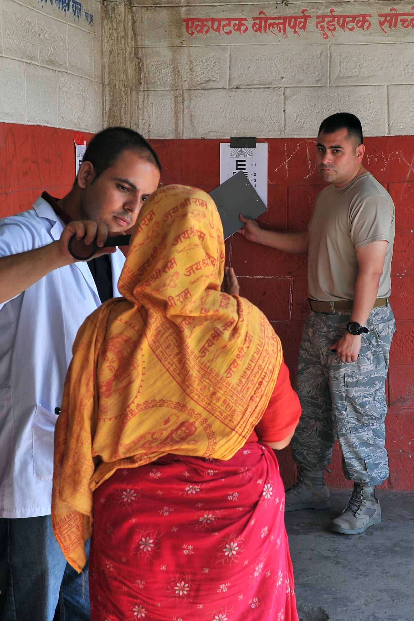 U.S. Air Force Staff Sgt. Nemesio Perez, Operation Pacific Angel-Nepal optometry technician, and Dr. Santosh Bhusal, Nepalese optometrist, perform a visual acuity test on a patient at a health services outreach site in Manahari, Nepal, Sept. 8, 2014. PACANGEL supports U.S. Pacific Command’s capacity-building efforts by partnering with other governments, non-governmental agencies and multilateral militaries in the respective region to provide medical, dental, optometry and engineering assistance to their citizens. (U.S. Air Force photo by Staff Sgt. Melissa B. White/Released)
