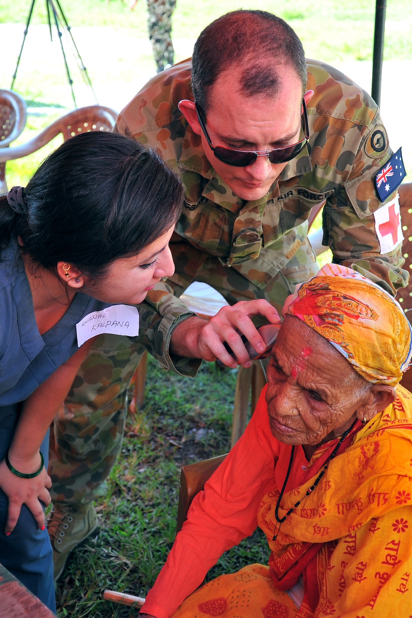 Royal Australian Air Force Leading Aircraftsman Michael Youngberry, Operation Pacific Angel-Nepal medical assistant, takes a patient’s vital signs at a health services outreach location in Manahari, Nepal, Sept. 8, 2014. PACANGEL helps cultivate common bonds and foster goodwill between the U.S., Nepal and regional nations by conducting multilateral humanitarian assistance and civil military operations. (U.S. Air Force photo by Staff Sgt. Melissa B. White/Released)