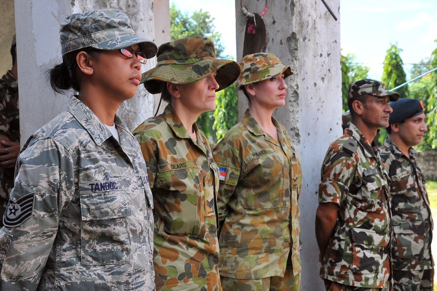 U.S. Air Force, Royal Australian Air Force, and Nepalese Army service members watch the Pacific Angel-Nepal opening ceremony in Manahari, Nepal, Sept. 8, 2014. PACANGEL supports U.S. Pacific Command’s capacity-building efforts by partnering with other governments, non-governmental agencies and multilateral militaries in the respective region to provide medical, dental, optometry and engineering assistance to their citizens. (U.S. Air Force photo by Staff Sgt. Melissa B. White/Released)
