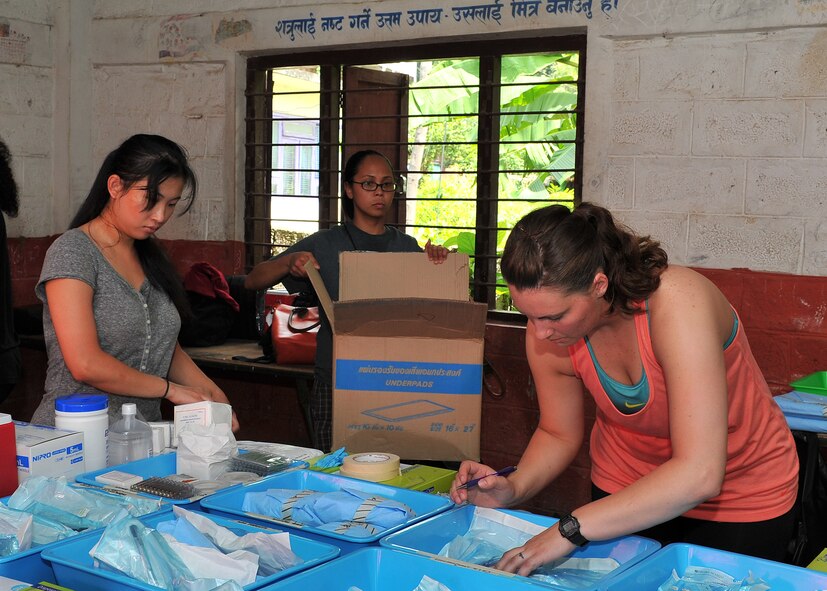 U.S. Air Force and Navy members prepare the dental care area at a health services outreach site in Manahari, Nepal, Sept. 7, 2014, to prepare for Operation Pacific Angel-Nepal. Operation PACANGEL helps cultivate common bonds and foster goodwill between the U.S., Nepal and regional nations by conducting multilateral humanitarian assistance and civil military operations. (U.S. Air Force photo by Staff Sgt. Melissa B. White/Released)