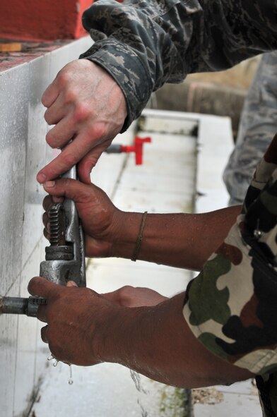 A U.S. Air Force Airman and a Nepalese Army Soldier work together to repair water fixtures at a school in Manahari, Nepal, Sept. 7, 2014, for Operation Pacific Angel-Nepal. PACANGEL supports U.S. Pacific Command’s capacity-building efforts by partnering with other governments, non-governmental agencies and multilateral militaries in the respective region to provide medical, dental, optometry and engineering assistance to their citizens. (U.S. Air Force photo by Staff Sgt. Melissa B. White/Released)