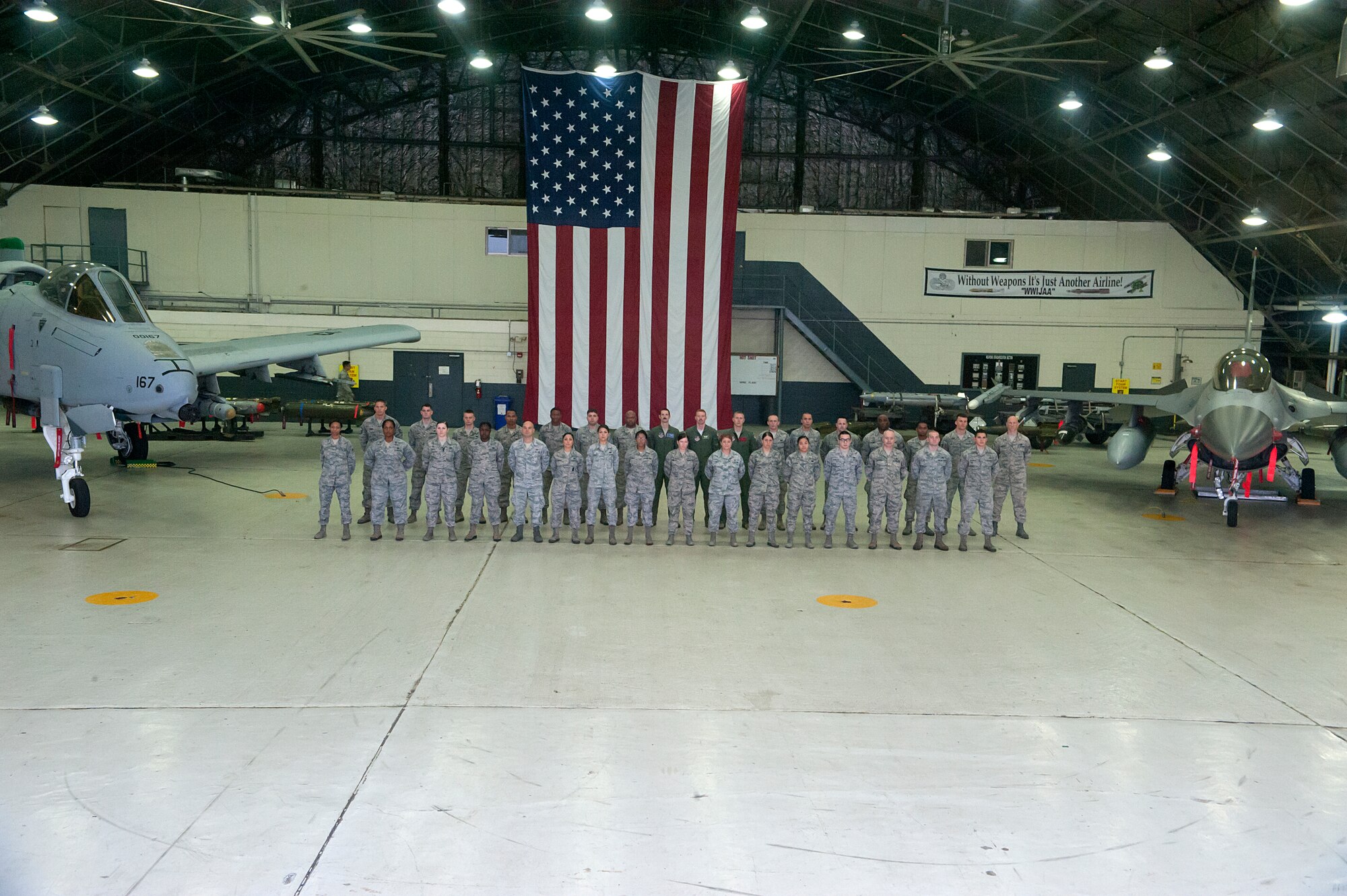 Team Osan members with an A-10 Thunderbolt II and a F-16 Fighting Falcon at Osan Air Base, Republic of Korea, Sept. 8, 2014. The Korea Readiness Orientation Program is a 30 day program to better prepare incoming Airmen for the mission in the ROK. (U.S. Air Force photo by Senior Airman Matthew Lancaster)