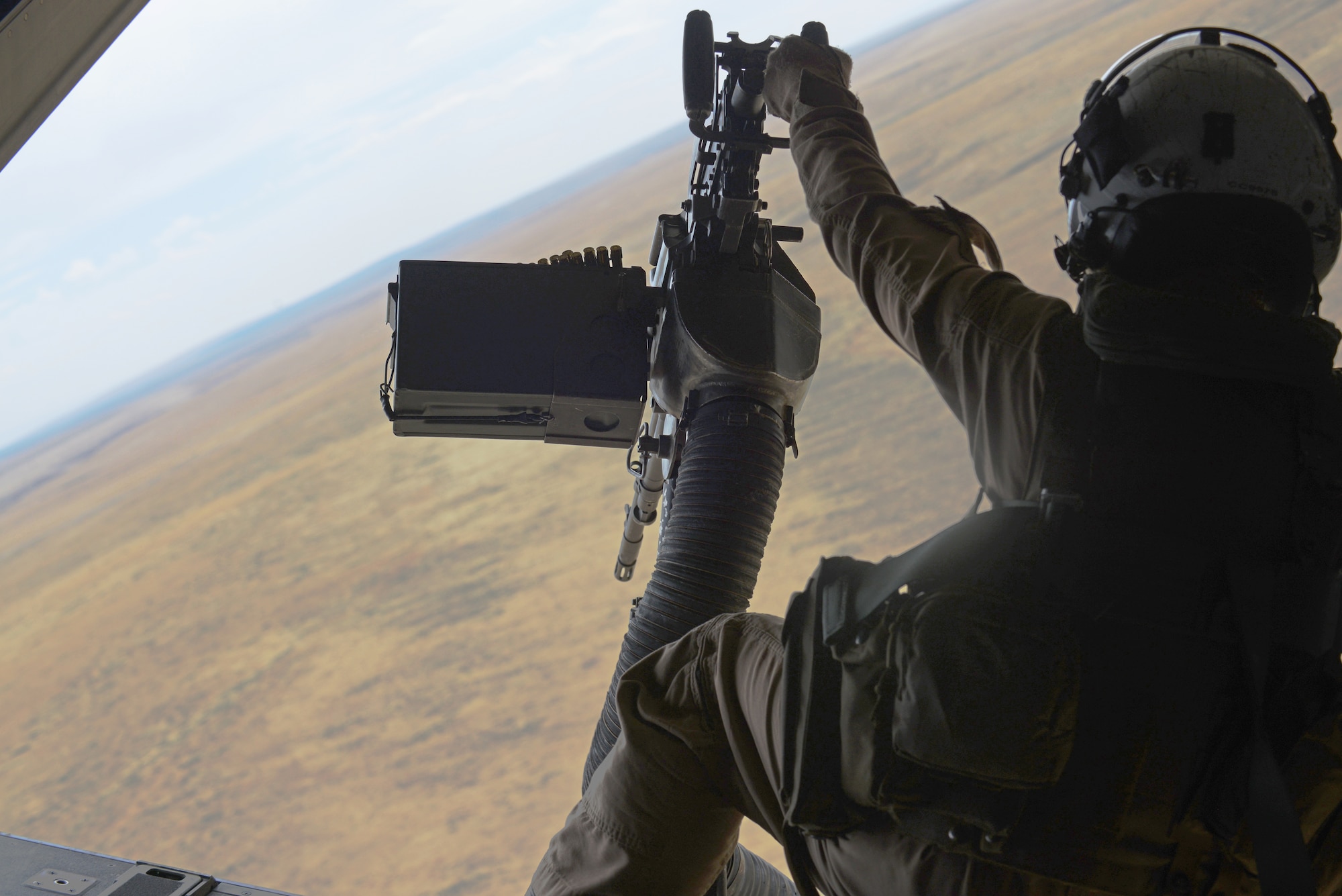 An aerial gunner assigned to the Marine Medium Tiltrotor Squadron 161, 3rd Marine Aircraft Wing, Miramar, Calif., prepares before landing Sept. 8, 2014, at the Saylor Creek Range Complex, Idaho. Crews flying the MV-22B are conducting multiple operations throughout the week as part of combat training for both air and ground crew. (U.S. Air Force photo by Senior Airman Benjamin Sutton/Released)  