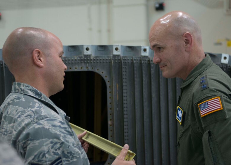 U.S. Air Force Tech. Sgt. Kenneth Pratt, 317th Maintenance Squadron C-130J isochronal dock chief, explains a piece of equipment from a wing that has been altered to facilitate training to Lt. Gen.  Carlton D. Everhart II, 18th Air Force commander, Aug. 27, 2014, at Dyess Air Force, Texas. The alteration was a joint effort between the 317th Airlift Group and 7th Bomb Wing, and allows for aircraft maintainers to understand the interior structure of an aircraft wing. (U.S. Air Force photo by Senior Airman Peter Thompson/Released)