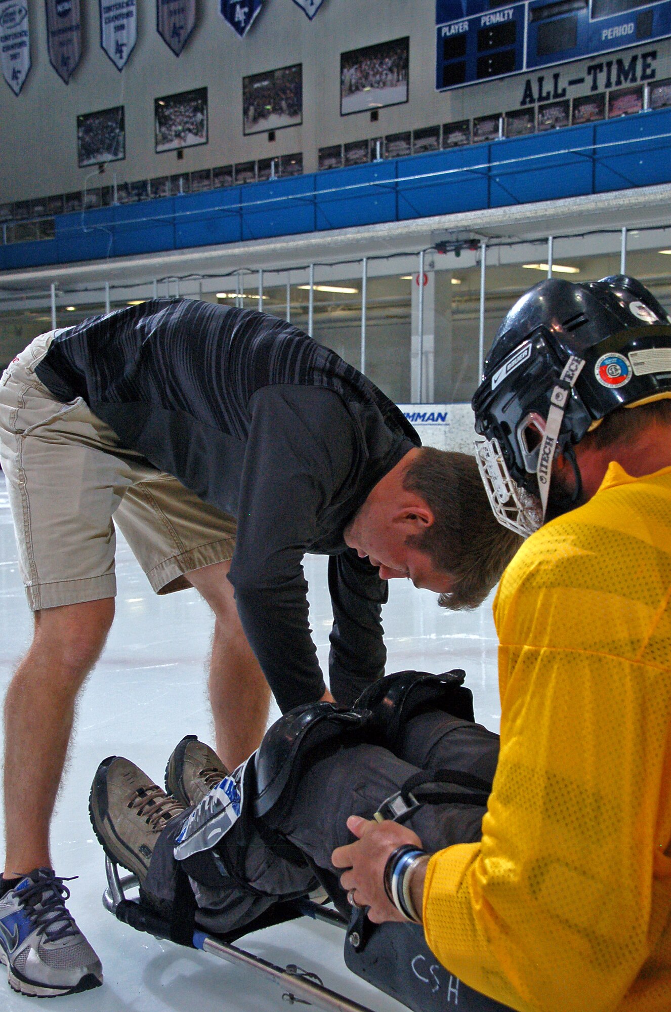 Cadet 2nd Class Christopher Dylewski secures a wounded warrior's legs to a hockey
sled at Clune Arena Sept. 7. (U.S. Air Force photo/Cadet 3rd Class ShuJie Yan)
