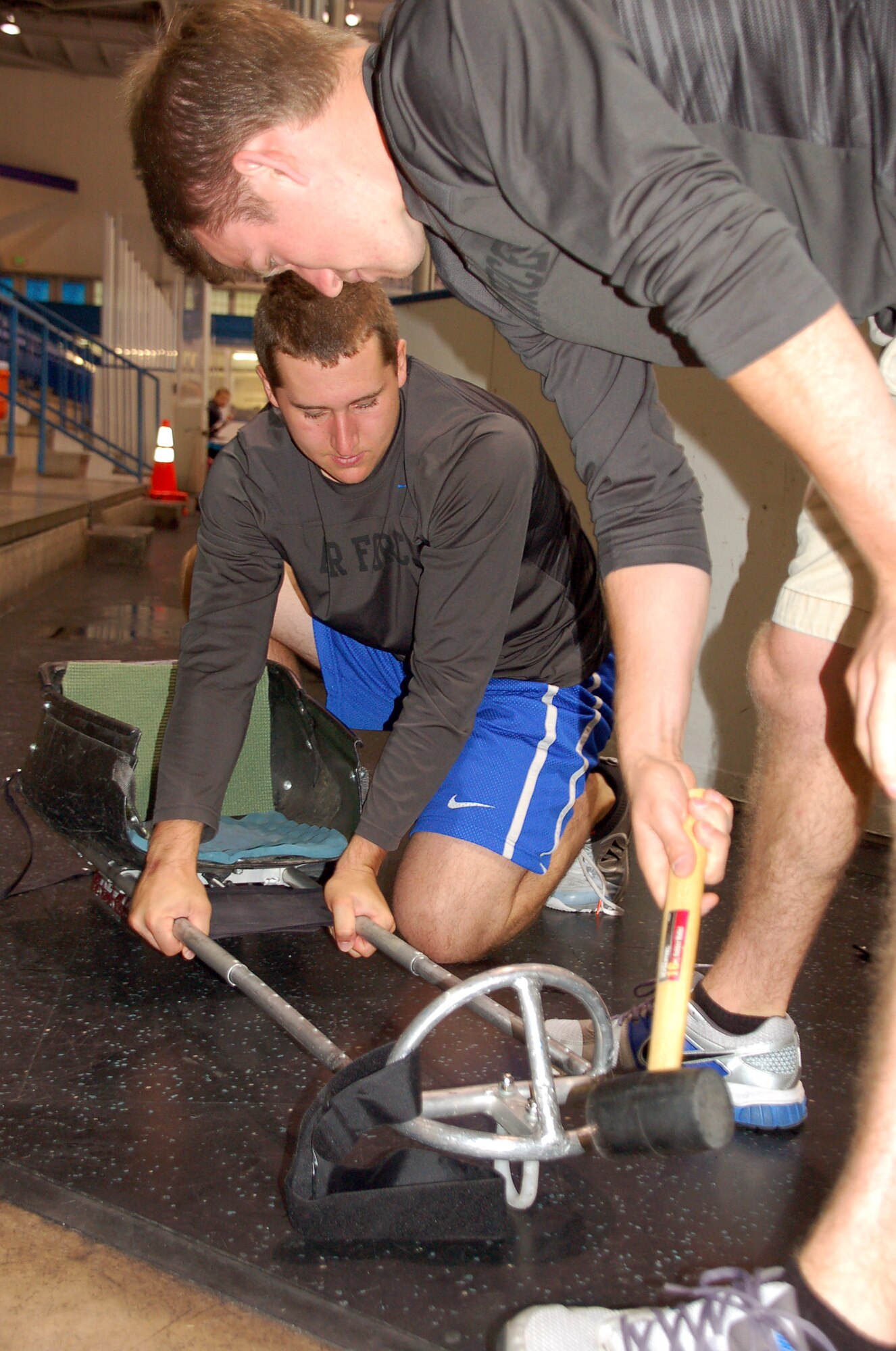 Cadet 2nd Class Christopher Dylewski (right) and a Falcon Hockey teammate adjust a hockey sled at Clune Arena Sept. 7. (U.S. Air Force Photo/Cadet 3rd Class ShuJie Yan)