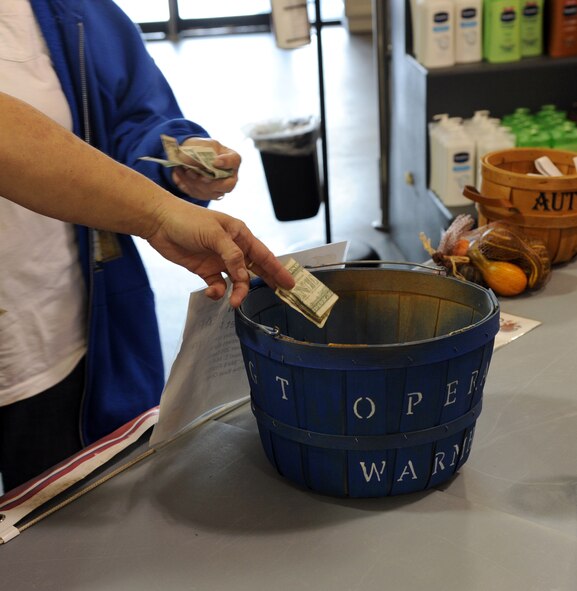 Patrons donate to the Operation Warm-Heart program on Barksdale Air Force Base, La., Sept. 3, 2014. The OWH program grants the First Sergeant?s Council the ability to assist Airmen and their families in need of financial assistance. (U.S. Air Force photo/Senior Airman Jannelle Dickey)