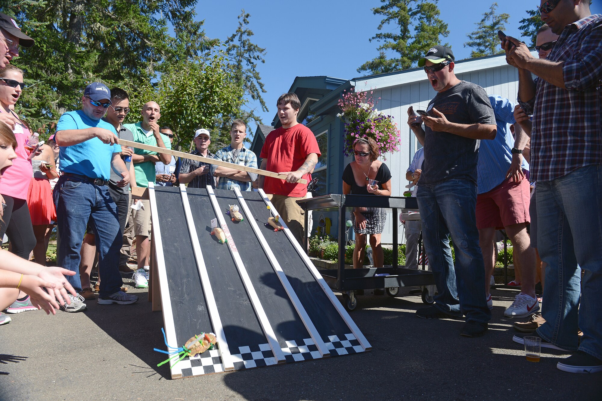 Participants of the annual Foofaraw event watch a potato race Sept. 5, 2014, on Island Home, Wash. The potato race is a Foofaraw tradition where attendees on each yacht design their own potato to compete in the race later in the day. (U.S. Air Force photo/Airman 1st Class Keoni Chavarria)