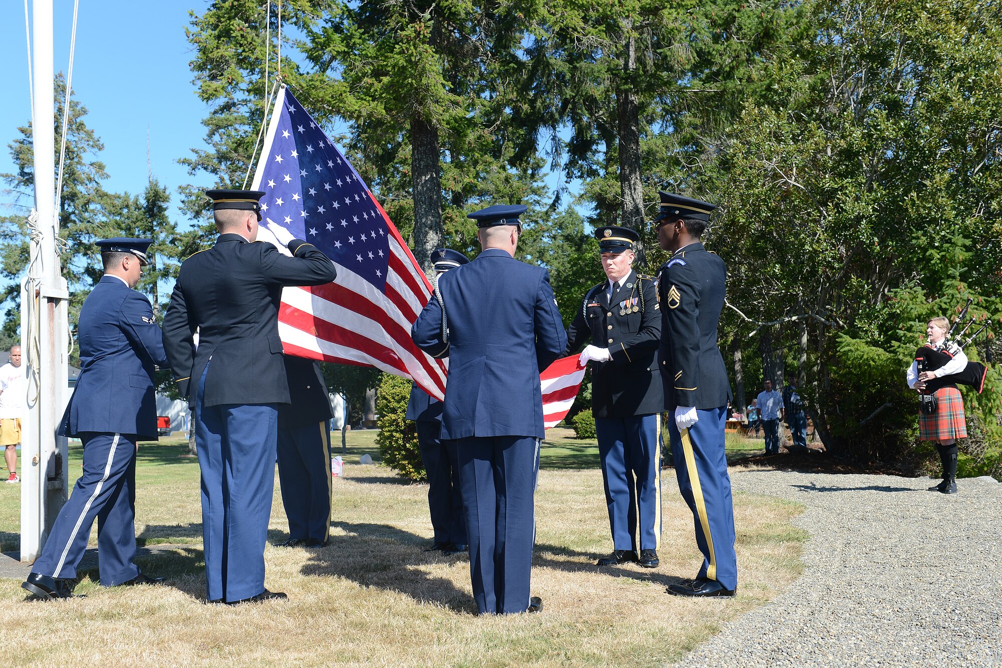 U.S. Air Force and Army Honor Guard members raise the U.S. flag Sept. 5, 2014, during Foofaraw on Island Home, Wash. Foofaraw is an annual event held by the Olympia Yacht Club and the Thurston County Chamber of Commerce to honor military service members. (U.S. Air Force photo/Airman 1st Class Keoni Chavarria)