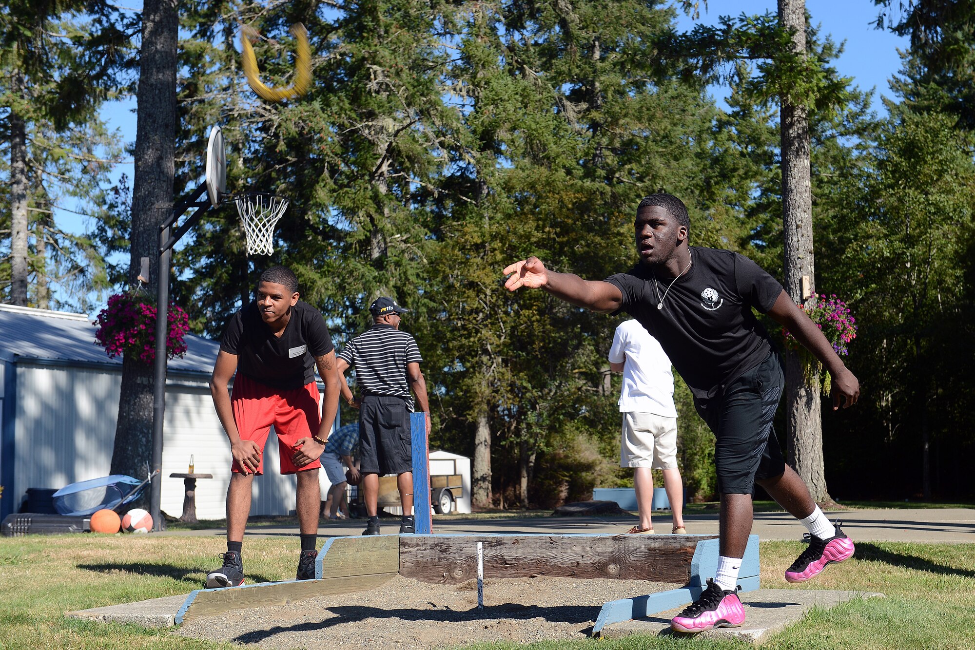 Carl Robertson, 62nd Operations Support Squadron aircrew flight equipment technician, throws a horseshoe Sept. 5, 2014, during Foofaraw on Island Home, Wash.  Island Home, owned by the Olympia Yacht Club, hosted Foofaraw in which attendees were able to play games such as volleyball, basketball and golf. (U.S. Air Force photo/Airman 1st Class Keoni Chavarria)