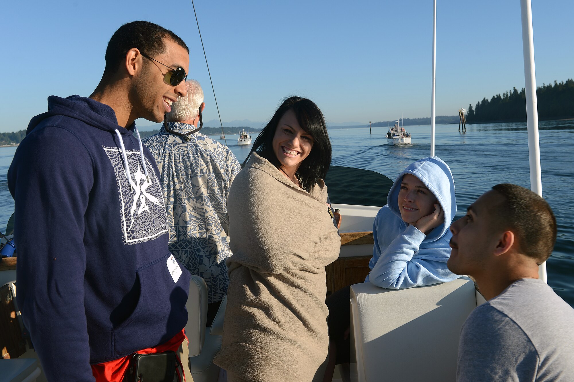 Service members from Joint Base Lewis-McChord converse with one another on a yacht Sept. 5, 2014, on their way to the annual Foofaraw event at Island Home, Wash. Thurston County Chamber of Commerce, with the help of the Olympia Yacht Club, hosted Foofaraw, giving participating military service members a day to eat free food, play games, and meet new people. (U.S. Air Force photo/Airman 1st Class Keoni Chavarria)