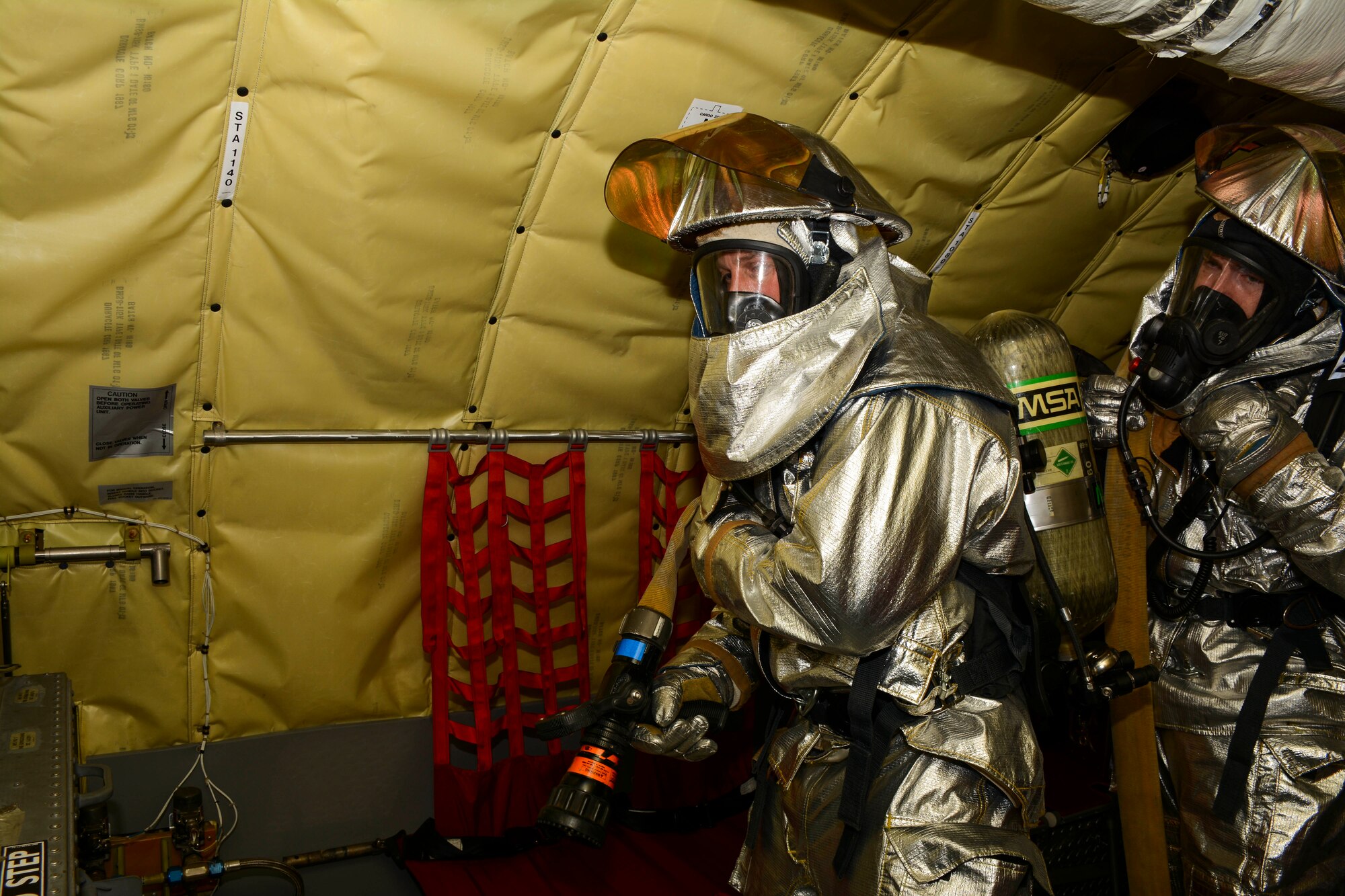Firefighters from the 507th Air Refueling Wing Civil Engineer Squadron enter a simulated disabled KC-135R Stratotanker and search the rear of the aircraft preparing to put out any fires they encounter.  The training was part of a quarterly super unit training assembly held by members of the CES in order to fulfill training requirements that cannot normally be done on a regular drill weekend.  (U.S. Air Force photo/Senior Airman Mark Hybers)