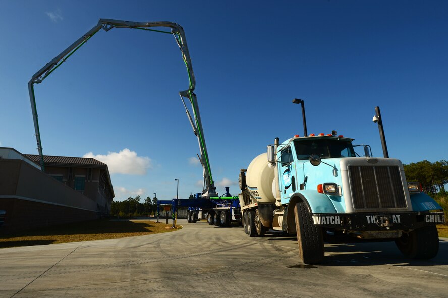 During a concrete laying project behind Patton Hall, the 20th Civil Engineer Squadron horizontal repair shop Airmen laid 14 cubic-yards of concrete at Shaw Air Force Base, S.C., Sept. 4, 2014. Throughout the two week project, approximately 10 20th CES Airmen laid concrete around four power generator units. (U.S. Air Force photo by Airman 1st Class Jensen Stidham/Released) 