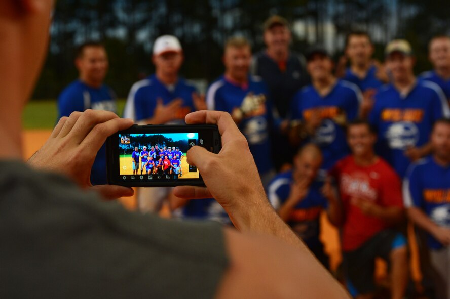 Members of the 20th Aircraft Maintenance Squadron softball team get their picture taken after playing in the intramural softball championship at Shaw Air Force Base, S.C., Sept. 2, 2014. The 20th Civil Engineer Squadron Fire Department defeated the 20th AMXS 5-4. (U.S. Air Force photo by Airman 1st Class Jensen Stidham/Released)