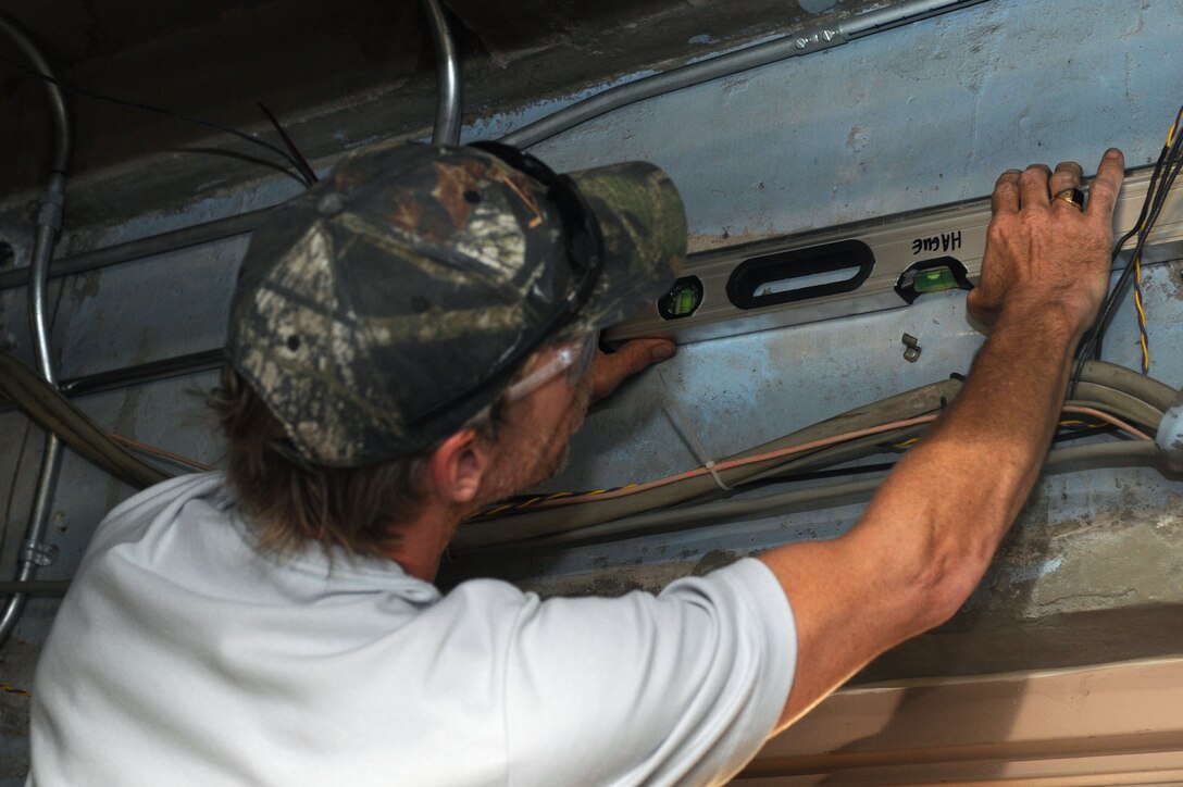 Dave Hague, 28th Civil Engineer Squadron Heating, Ventilation, Air Conditioning and Refrigeration technician, services an electrical wire conduit pipe at Ellsworth Air Force Base, S.D., Sept. 4, 2014. The 28th CES HVAC/R shop has been focused on installing and repairing boilers in preparation for the winter season. (U.S. Air Force photo by Senior Airman Hailey R. Staker/Released)