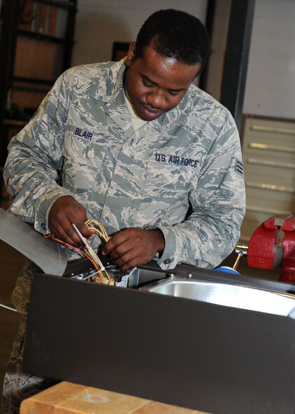 Senior Airman Cordell Blair, 28th Civil Engineer Squadron electrical systems journeyman, works on a lamp at Ellsworth Air Force Base, S.D., Sept. 4, 2014. Blair and other Airmen from the electrical systems shop maintain, troubleshoot and repair various equipment throughout the base in order to maximize their life span. Between weather and general aging, the lamp posts can decay if made of wood, and rust if made of metal. (U.S. Air Force photo by Senior Airman Hailey R. Staker/Released)
