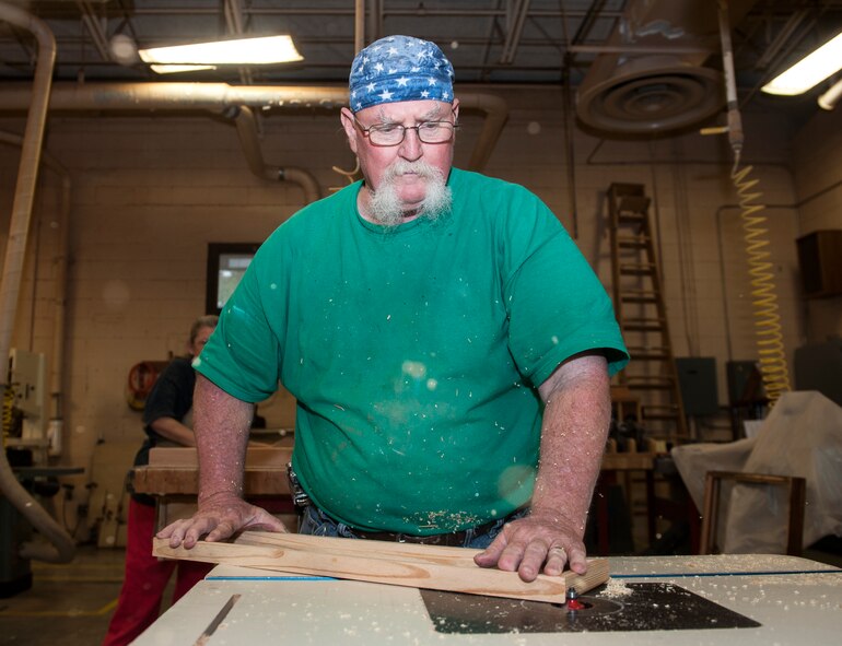 John Fischbach Sr., 23d Force Support Squadron recreation aide, smoothes the edges of a Moody Field sign Aug. 19, 2014, at Moody Air Force Base, Ga. Fischbach is the sole woodworker in the Moody woodshop, with the help of his wife Gail who volunteers there. (U.S. Air Force photo by Senior Airman Jarrod Grammel/Released)
