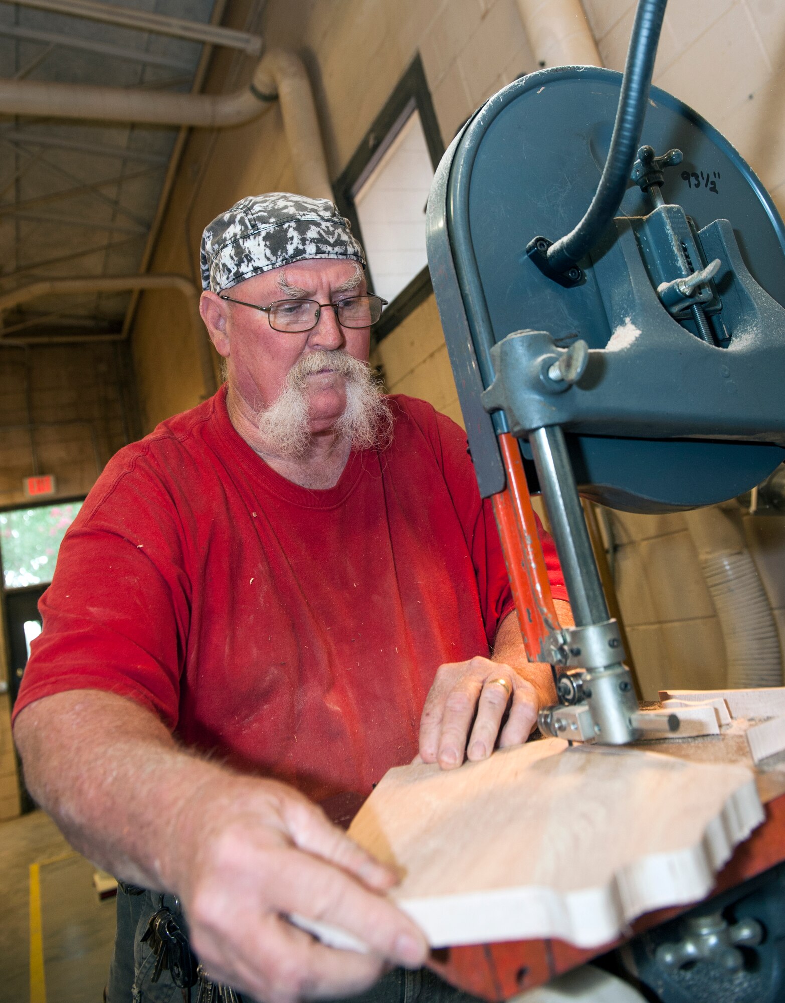 John Fischbach Sr., 23d Force Support Squadron recreation aide, cuts a block of wood into the shape of Georgia Aug. 1, 2014, at Moody Air Force Base, Ga. After Fischbach cuts the block of wood and sands the edges, he will pass the project off to the plaque shop to engrave it before he puts finish on the wood and stains it. (U.S. Air Force photo by Senior Airman Jarrod Grammel/Released)
