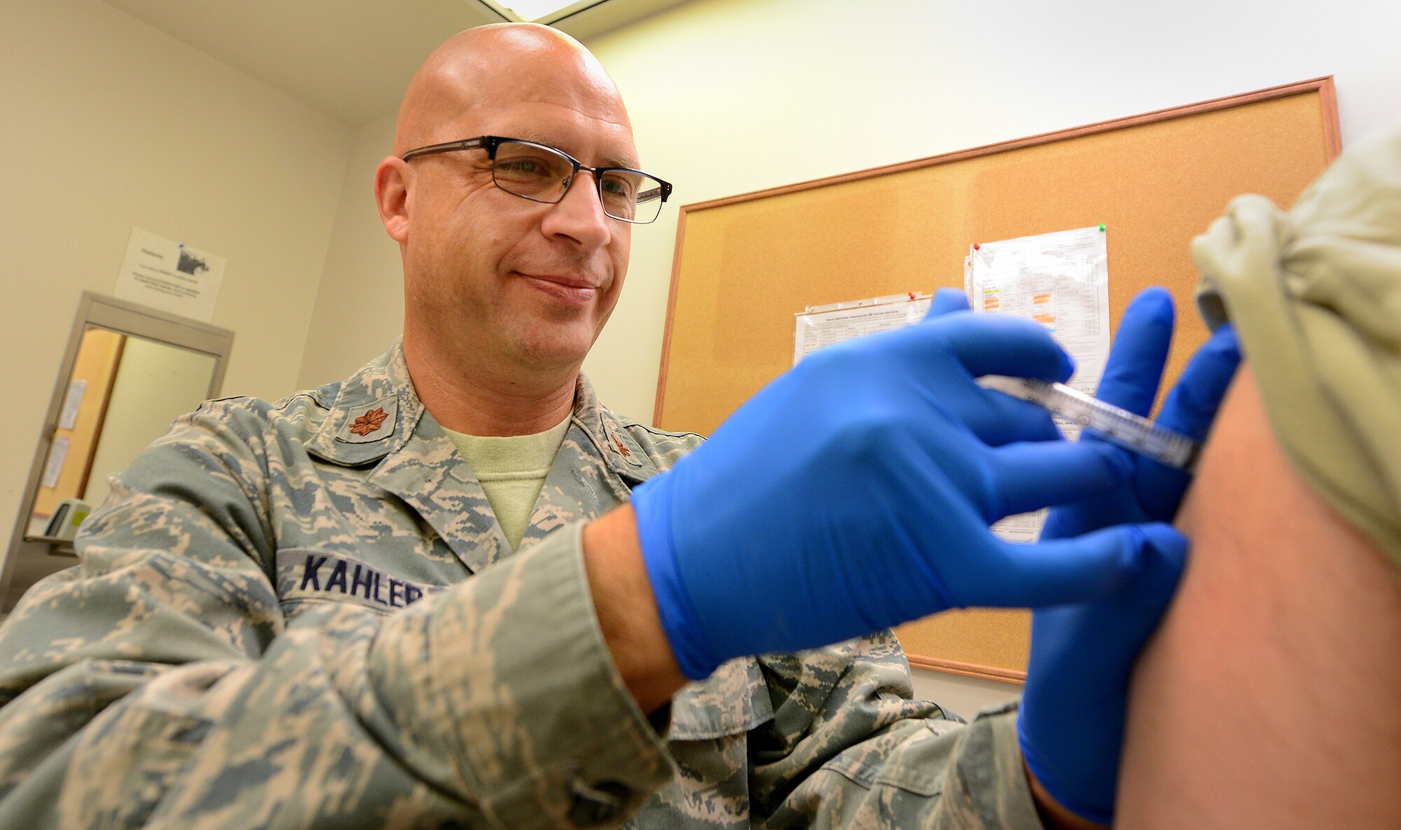 WRIGHT-PATTERSON AIR FORCE BASE, Ohio - Maj. Kim Kahler, 445th Aerospace Medicine Squadron officer-in-charge of immunizations, administers a shot at the Wright Patterson Air Force Base Medical Center August 2, 2014. The unit averages 100-150 shots per month. Immunizations is one of the many functions of the AMDS that helps Airmen from the 445th Airlift Wing stay current with their medical requirements for the Air Force Reserve. (U.S. Air Force photo/Tech. Sgt. Frank Oliver) 