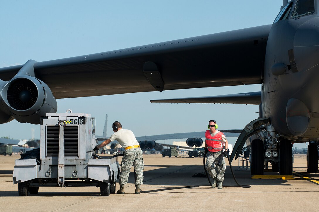 U.S. Air Force Tech. Sgt. Bryan Fields (right) and Airman 1st Class Justin Wharff, 2nd Aircraft Maintenance Squadron crew chiefs, disconnect an external power unit from a 307th Bomb Wing (BW) B-52H Stratofortress prior to a mission on Aug. 28, 2014, Barksdale Air Force Base, La. On board the aircraft is Col. William Lyons, Assistant Vice Commander and the Director of Staff for 10th Air Force, who visited the 307th BW and flew his first flight in a B-52. (U.S. Air Force photo by Master Sgt. Greg Steele/Released)