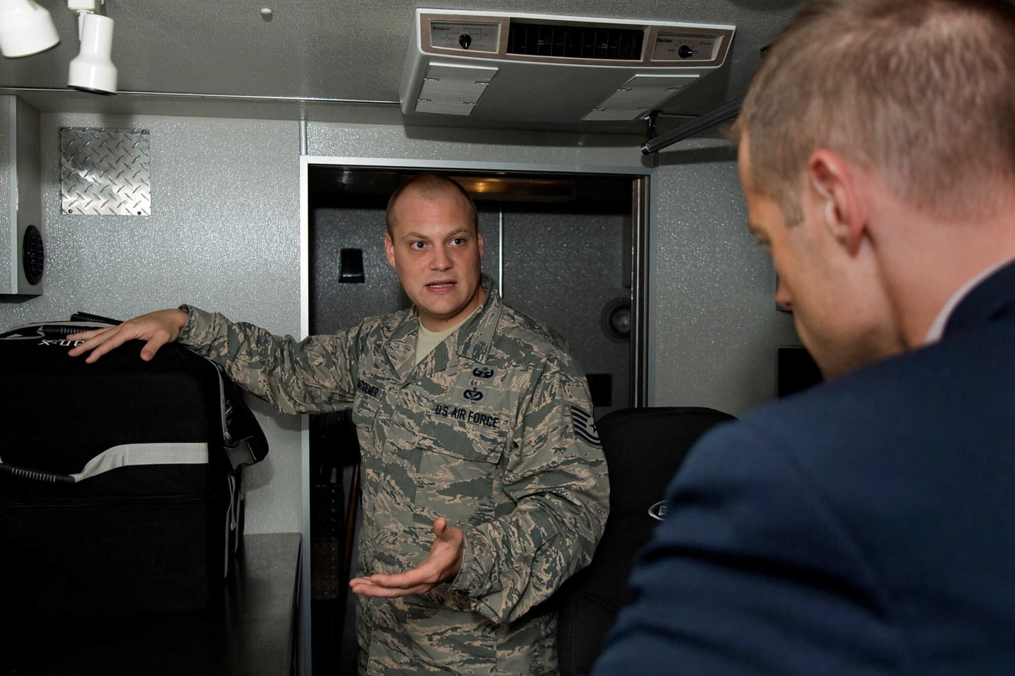 Tech. Sgt. Justin Krautkremer, 434th Civil Engineer Squadron explosive ordnance disposal technician, talks with Sam Fletcher, military legislative assistant for Rep. Jackie Walorski, about EOD at Grissom Air Reserve Base, Ind., Aug. 27, 2014. Fletcher visited the base to learn more about the 434th Air Refueling Wing and its mission. (U.S. Air Force photo/Tech. Sgt. Mark R. W. Orders-Woempner) 
