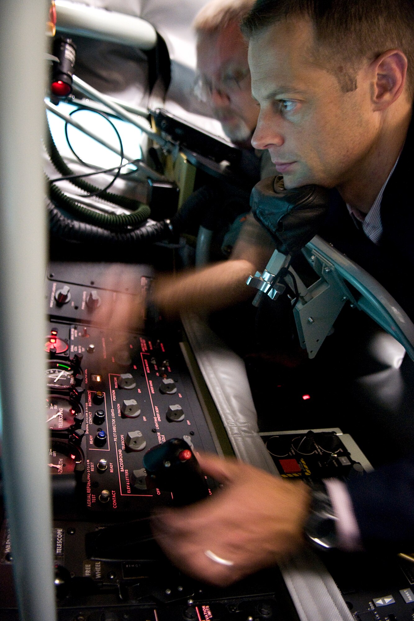 Sam Fletcher, military legislative assistant for Rep. Jackie Walorski, right, attempts to refuel a simulated F-22 Raptor as Mike Conner, a contract trainer, assists him in a boom operator weapons system trainer at Grissom Air Reserve Base, Ind., Aug. 27, 2014. Fletcher visited the base to learn more about the 434th Air Refueling Wing and its mission. (U.S. Air Force photo/Tech. Sgt. Mark R. W. Orders-Woempner) 

