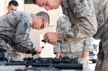 Staff Sgt. Ryan Fontaine, 219th Security Forces Squadron member, and Airman 1st Class Brandon Weese, 791st Missile Security Forces Squadron member, assemble M4 rifles during training on Minot Air Force Base, N.D., Sept. 4, 2014. Fontaine and Weese are members of the 91st Security Forces Group Global Strike Challenge team.  (U.S. Air Force photo/Senior Airman Brittany Y. Bateman)