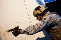Senior Airman Cody Poole, 91st Security Forces Group tactical response force member, fires an M9 Berretta during training on Minot Air Force Base, N.D., Sept 3, 2014. Poole is a member of the 91st Security Forces Group Global Strike Challenge team.  (U.S. Air Force photo/Senior Airman Brittany Y. Bateman)