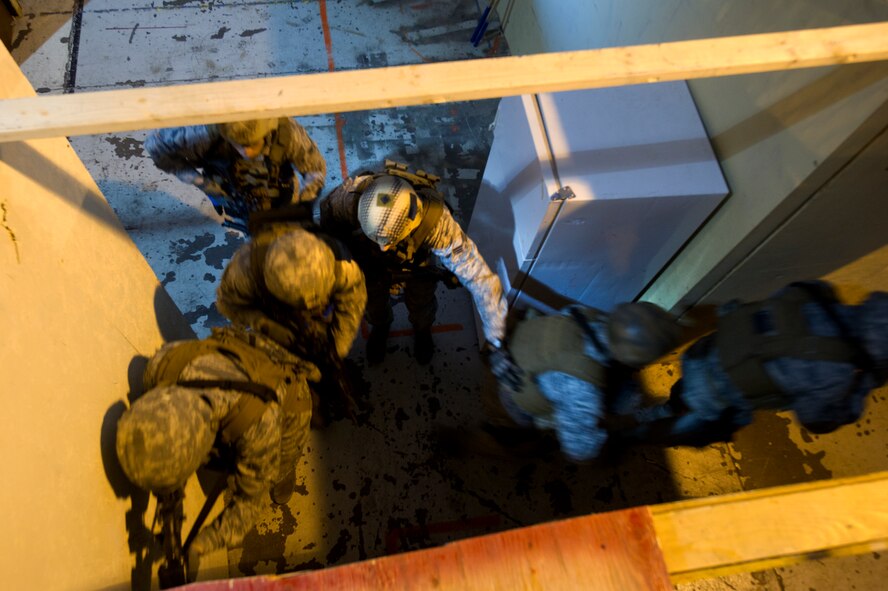 Members of the 91st Security Forces Group Global Strike Challenge team practice building clearing techniques on Minot Air Force Base, N.D., Sept. 4, 2014. In conjunction with the Air National Guard, Minot Air Force Base is sending a joint team of defenders to represent the missile wing. (U.S. Air Force photo/Senior Airman Brittany Y. Bateman)