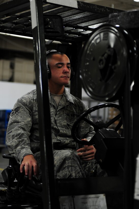 U.S. Air Force Senior Airman Jordan Mueller, 633rd Logistics Squadron packing and crating specialist, uses a forklift to place cargo on a scale at Langley Air Force Base, Va., Sept. 3, 2014. Airmen working with cargo can sometimes move items such as aircraft engines, gym equipment and other supplies on a daily basis. (U.S. Air Force photo by Airman 1st Class Areca T. Wilson/Released) 