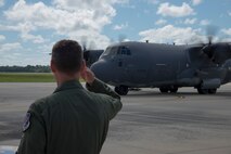 U.S. Air Force Col. Chad Franks, 23d Wing commander, salutes as Maj. Gen. H.D. Polumbo Jr., 9th Air Force commander, arrives in a C-130J Hercules Sept. 4, 2014, at Moody Air Force Base, Ga. The general visited the base for a base tour and to meet Airmen from different units of the base. (U.S. Air Force photo by Staff Sgt. Eric Summers Jr.)