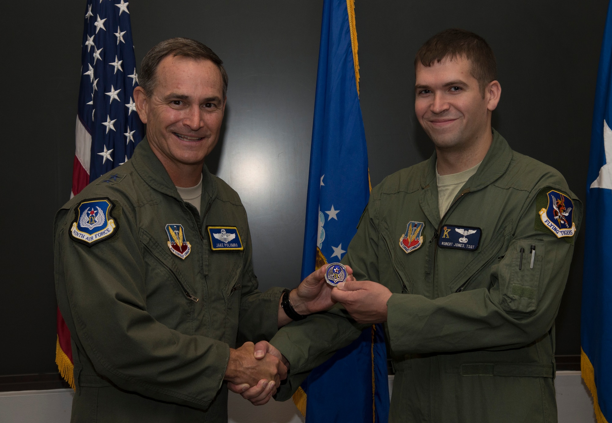Maj. Gen. H.D. Polumbo Jr., 9th Air Force commander, presents a coin to Tech. Sgt. Robert Jones, 71st Rescue Squadron HC-130P Combat King flight engineer, Sept. 4 at Moody Air Force Base, Ga. The general visited Moody for a base tour and recognized several Airmen for their hard work and dedication to the mission. (U.S. Air Force photo by Staff Sgt. Eric Summers Jr.) )