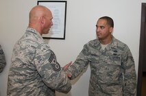 U.S. Air Force Staff Sgt. Randal Landers, 23d Civil Engineer Squadron infrastructures, receives a coin from Chief Master Sgt. Scott Fuller, 9th Air Force command chief, Sept. 4, 2014, at Moody Air Force Base, Ga. During his visit, the Chief coined several Airmen who were nominated by their senior leadership for hard work and performance. (U.S. Air Force photo by Staff Sgt. Eric Summers Jr. /Released)