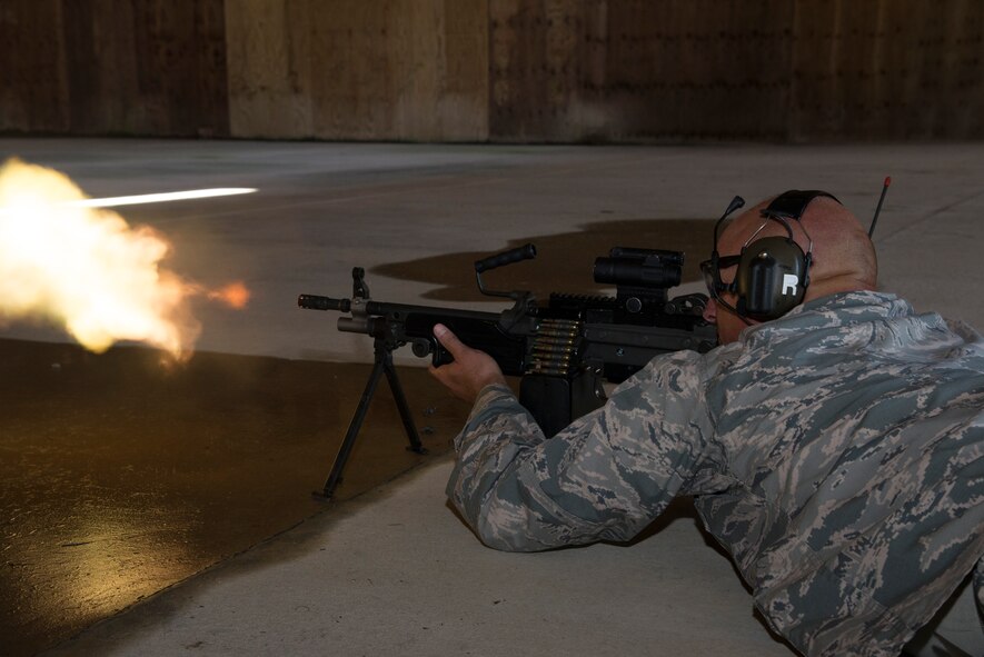 U.S. Air Force Chief Master Sgt. Scott Fuller, 9th Air Force command chief, fires a M249 light machine gun Sept. 4, 2014, at Moody Air Force Base, Ga. The 23d Security Forces combat arms training and maintenance flight gave the Chief the opportunity to use one of the weapons commonly used by the unit during deployments. (U.S. Air Force photo by Staff Sgt. Eric Summers Jr. /Released)