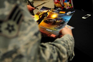 A U.S. Air Force Airman holds a signed photo of Michael Annett, NASCAR driver, during an autograph signing at the Exchange on Langley Air Force Base, Va., Sept. 4, 2014. Annett said he wanted to visit Langley after hearing about the history of the base. (U.S. Air Force photo by Airman 1st Class Breonna Veal/Released) (Photo was cropped and color corrected to emphasize subject.)