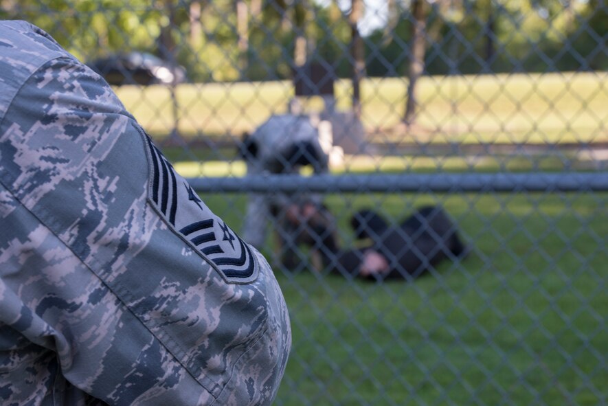 U.S. Air Force Chief Master Sgt. Scott Fuller, 9th Air Force command chief, watches a military working dog demonstration Sept. 4, 2014, at Moody Air Force Base, Ga. While visiting Moody AFB, the Chief saw demonstrations from the 23d Security Forces Squadron, 23d Civil Engineer Squadron and 23d Equipment Maintenance Squadron. (U.S. Air Force photo by Staff Sgt. Eric Summers Jr. /Released)