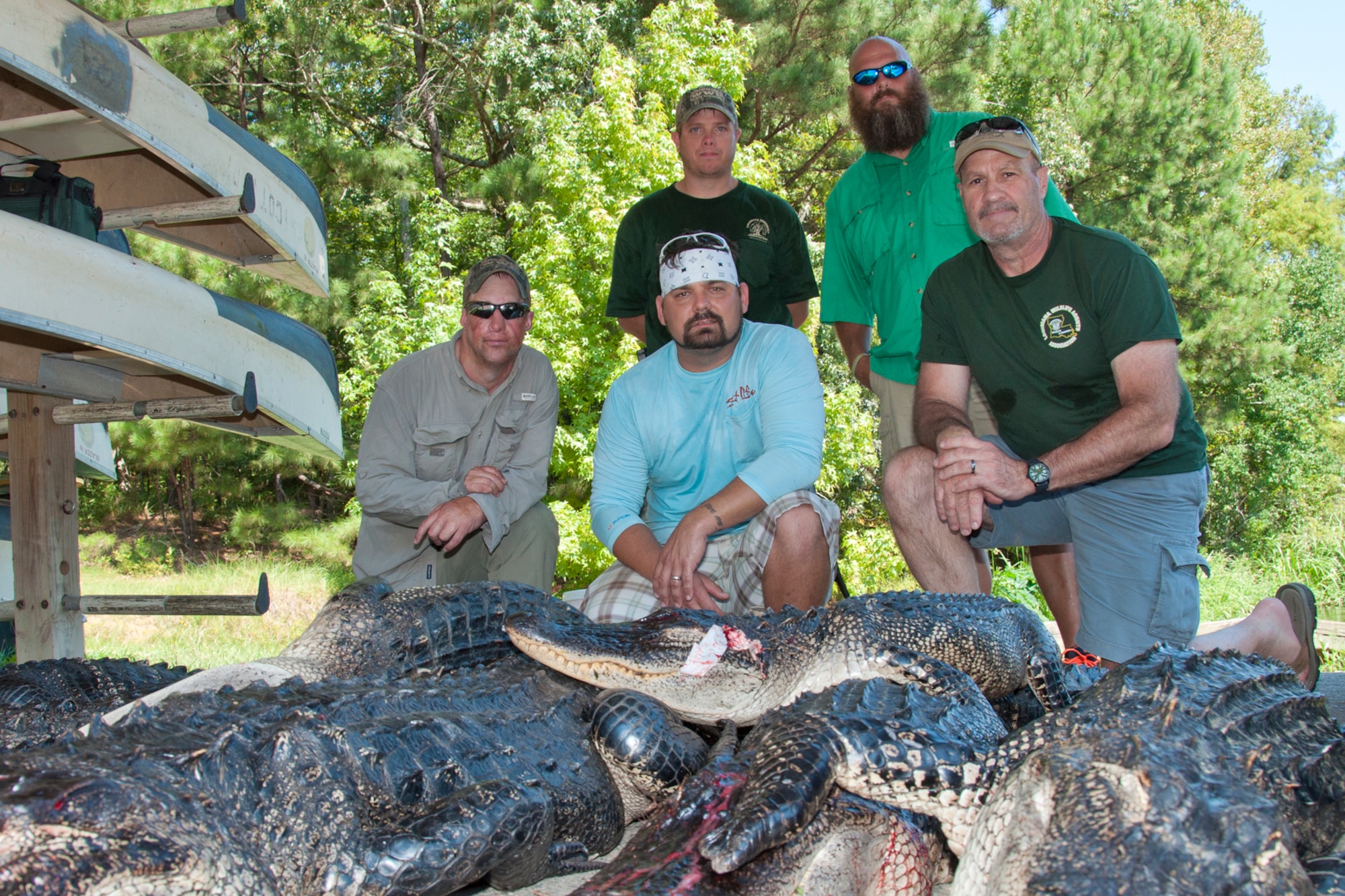 Four wounded warriors and U.S. Air Force Master Sgt. Darryl Moore, 307th Force Support Squadron first sergeant, pose with a stack of alligators at Chicot State Park, Ville Platte, La., Sept. 4, 2014.  Moore coordinated the hunt for the four veterans with the help of Wounded Warrior Heroes of Louisiana.  The group bagged 28 alligators during the hunt.  Bottom Row, left to right, John Purser, Anthony Cuccia IV, and Moore.   Top Row, left to right: Dustin Mince and Eric Broussard.  (U.S. Air Force photo by Tech. Sgt. Ted Daigle/release)