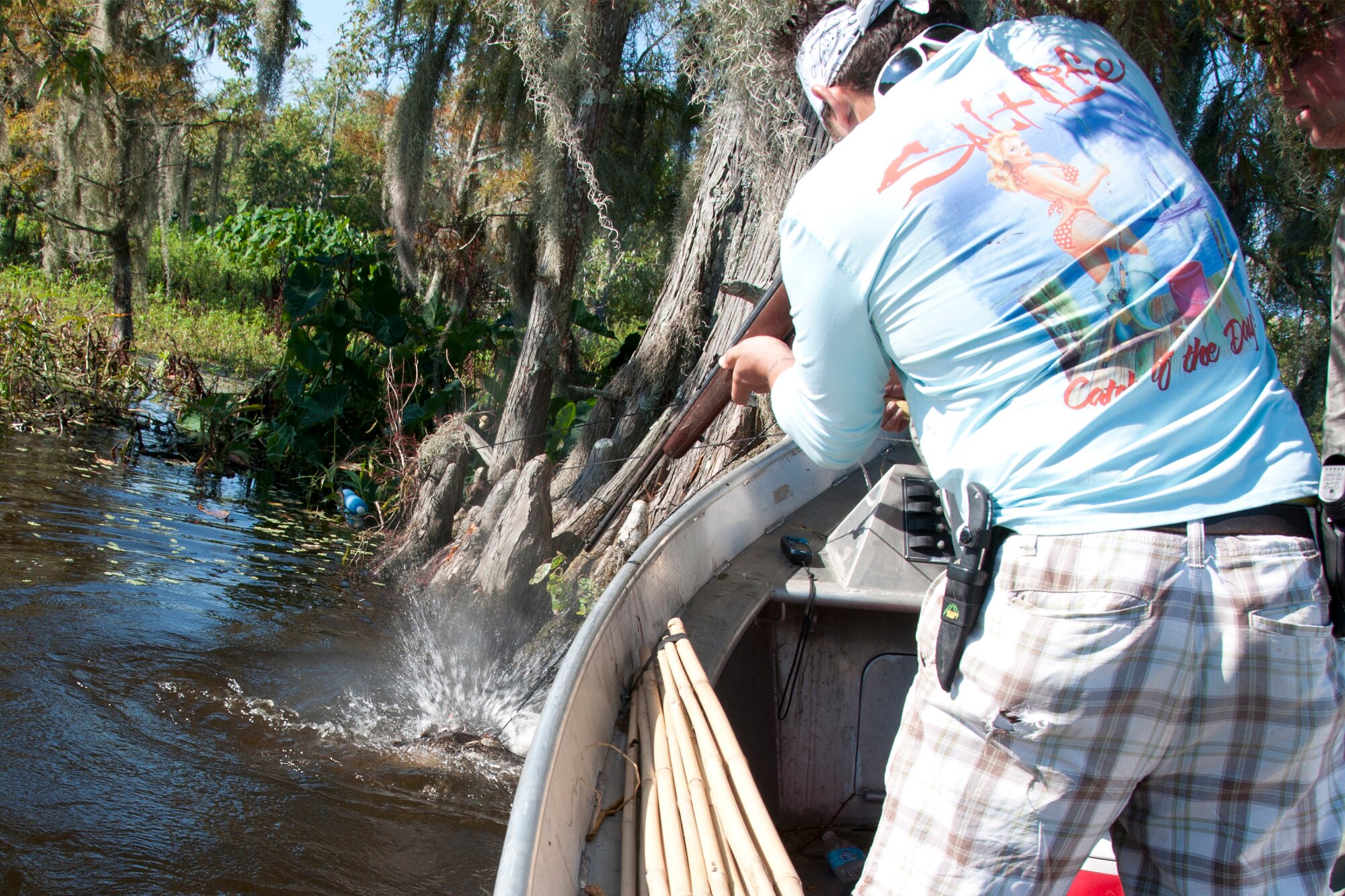 A round from the rifle of U.S. Army veteran Anthony Cuccia IV sends up a spray of water and spells the end of the line for one unlucky alligator at Chicot State Park, Ville Platte, La., Sept. 4, 2014.  Cuccia, who deployed to Iraq during his time in service, is one of four wounded warriors sponsored on the hunt by Master Sgt. Darryl Moore, 307th Force Support Squadron first sergeant.  The annual Louisiana alligator hunt is a unique tradition.  Moore wanted to give the wounded warriors a chance to experience the unique event and have time to enjoy the camaraderie, food and fun it offers.  (U.S. Air Force photo by Tech. Sgt. Ted Daigle/released)