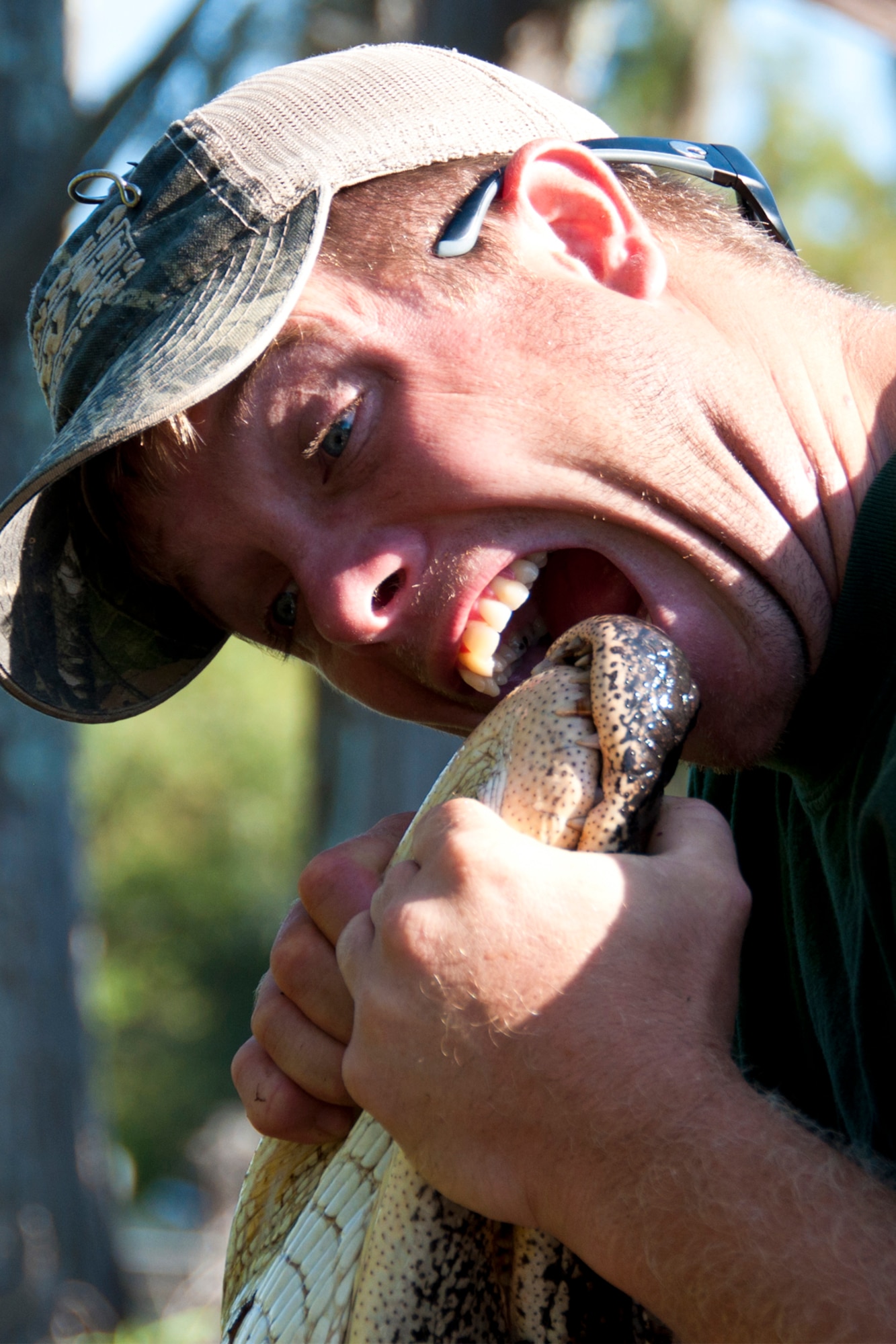 Dustin Mince, a U.S. Army combat veteran and wounded warrior, lets an alligator know he is the one at the top of the food chain during a hunt at Chicot State Park, Ville Platte, La., Sept. 4, 2014.   Mince and three other wounded combat veterans participated in the hunt thanks to the efforts of U.S. Air Force Master Sgt. Darryl Moore, 307th Force Support Squadron first sergeant, who coordinated the event.  Moore hosted the veterans with the help of Wounded War Heroes of Louisiana, a veteran outreach group.  The wounded warriors enjoyed three days of camaraderie, Cajun food and great hunting. (U.S. Air Force photo by Tech. Sgt. Ted Daigle/released)