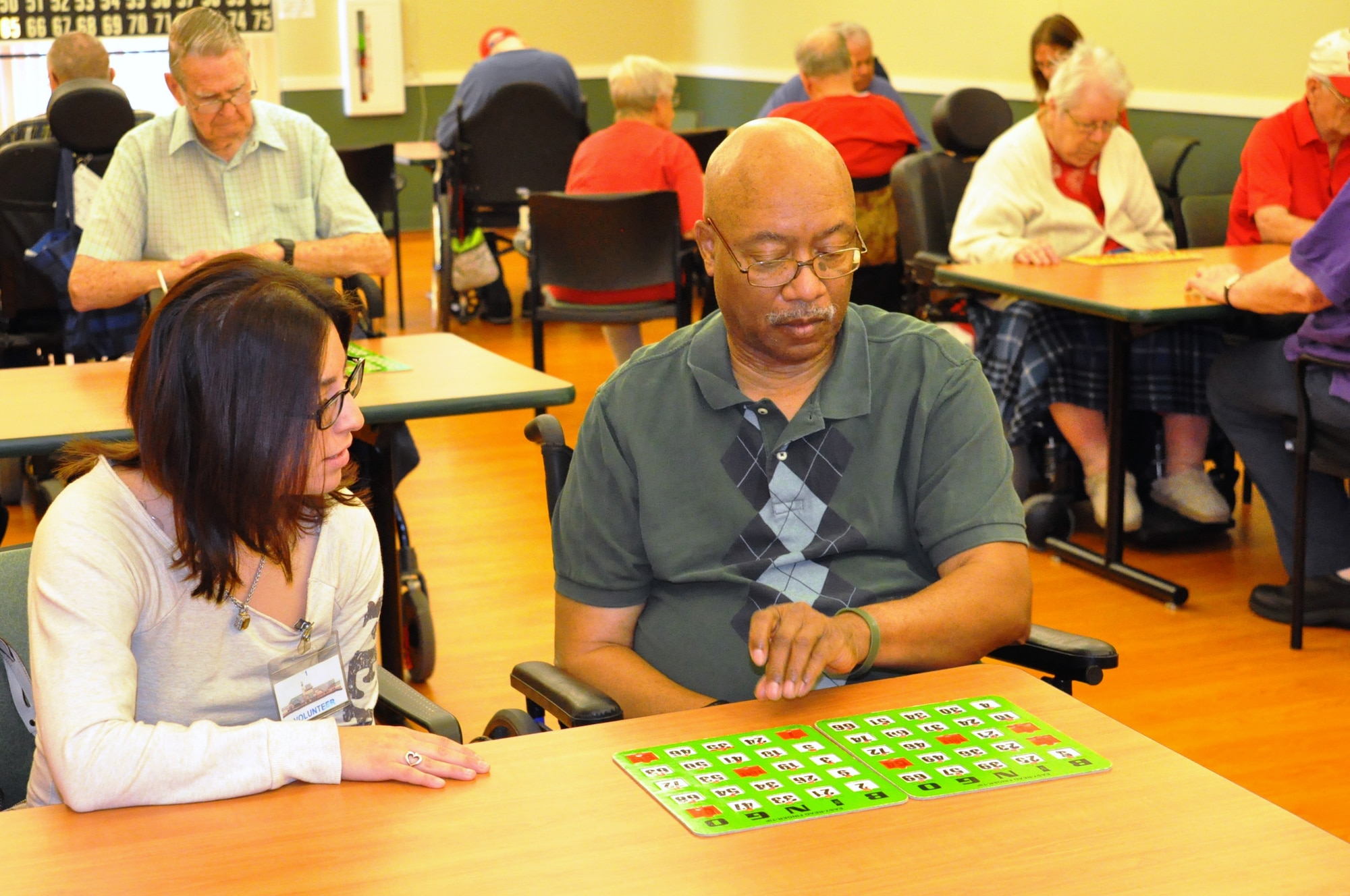 U.S. Air Force Airman 1st Class Brenda E. Posten, U.S. Strategic Command intelligence analyst and Elite Four community officer, assists members of the Easter Nebraska Veteran’s Home with bingo Sept. 6. The home is always looking for volunteers to help with bingo and other activities. (U.S. Air Force photo by Staff Sgt. Rachelle Blake)
