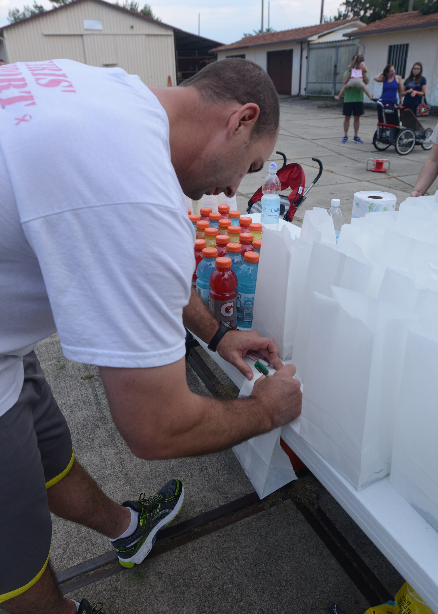 In memory, a 5k participant writes down the name of a victim of suicide as part of the Suicide Awareness Prevention Run Sept. 5, 2014, at Aviano Air Base, Italy. September 8th through the 14th is National Suicide Prevention Week. Suicide and suicidal behavior affect all people, regardless of gender, race, sexual, or religious orientation. (U.S. Air Force photo/Airman 1st Class Deana Heitzman)