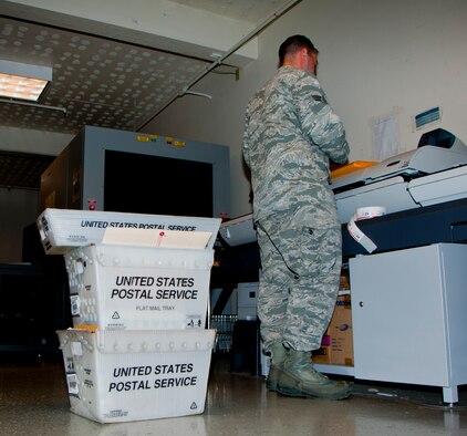 Senior Airman Michael Riggio, 60th Communications Squadron administrator, processes and sorts official mail Aug. 26, 2014, in the Official Mail Center. The mission of the OMC is to provide customers with the most cost effective, secure, and prompt methods of delivery and receipt of official communications. (U.S. Air Force photo by Senior Airman Charles Rivezzo)