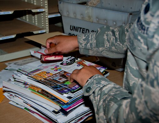 Senior Airman Tommy Armstrong, 60th Communications Squadron administrator, processes mail Aug. 26, 2014, in the Official Mail Center.  On average, the OMC processes 1,800 to 2,500 pounds of packages and official mail each week. (U.S. Air Force photo by Senior Airman Charles Rivezzo)