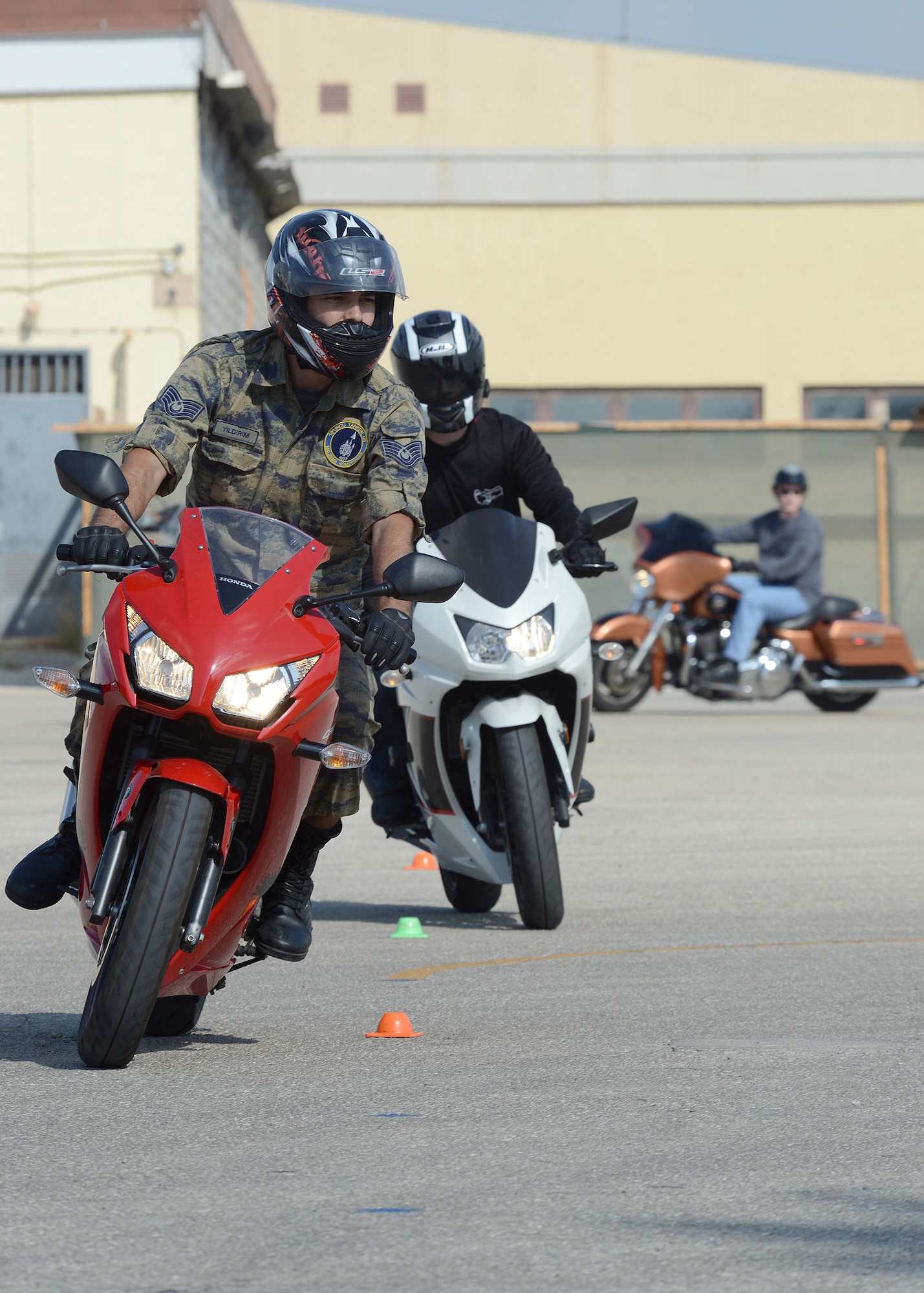 Airmen from the 39th Air Base Wing and Turkish air force ride in an obstacle course set up for a joint motorcycle safety demonstration Sept. 5, 2014, Incirlik Air Base, Turkey. The demonstration was modeled after the Motorcycle Safety Foundation Basic Rider Course 2, formerly known as the Experience Rider Course. (U.S. Air Force photo by Staff Sgt. Veronica Pierce/Released)