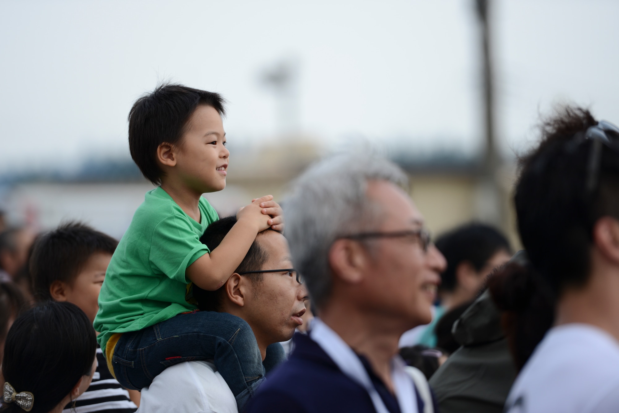 A boy smiles while watching a K-9 demonstration during the Japanese-American Friendship Festival at Yokota Air Base, Japan, Sept. 6, 2014. More than 148,000 attendees of all ages came to Yokota during the two-day festival to experience each other’s cultures and to see U.S. and Japanese military capabilities. (U.S. Air Force photo by Staff Sgt. Cody H. Ramirez/Released)