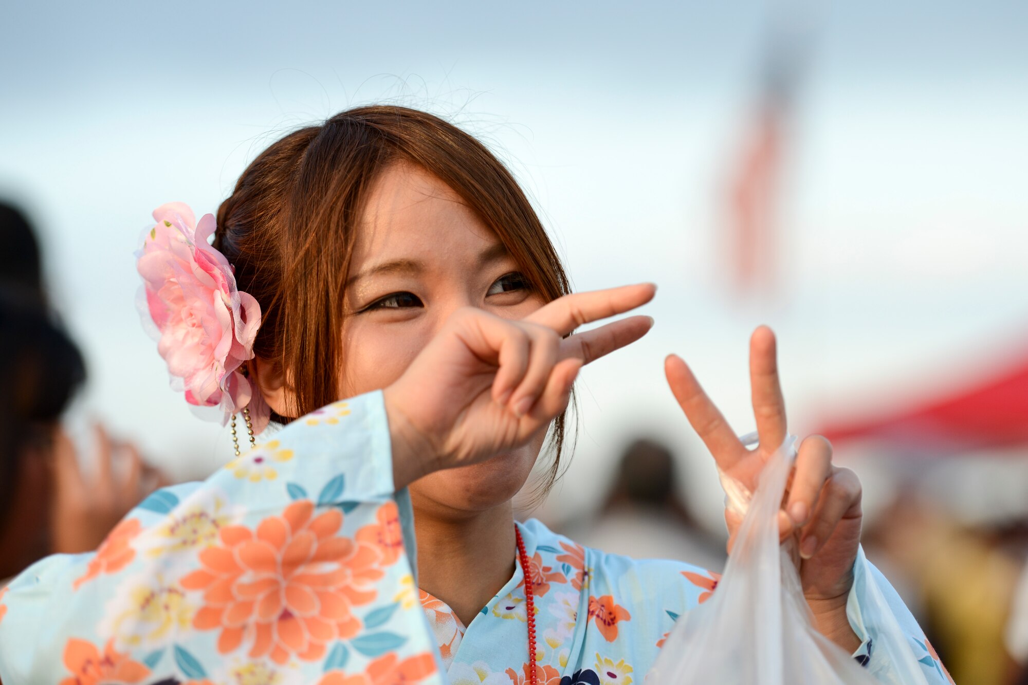 A woman wearing a traditional Japanese kimono poses for a photo during the 2014 Japanese-American Friendship Festival at Yokota Air Base, Japan, Sept. 7, 2014. During the two-day festival, Yokota hosted more than 148,000 attendees. The festival featured a variety of U.S. and Japanese military aircraft and offered an array of food booths and multicultural entertainment. (U.S. Air Force photo by Staff Sgt. Cody H. Ramirez/Released)