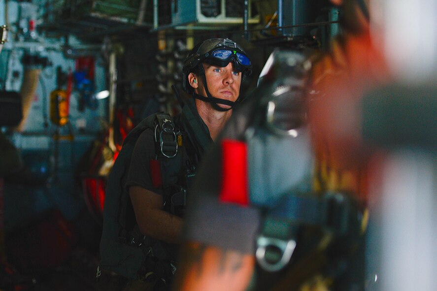 A pararescueman with the 31st Rescue Squadron prepares to jump out of a C-130 Hercules at Kadena Air Base, Aug. 27, 2014. The 31st RSQ worked with the 36th Airlift Squadron from Yokota Air Base, Japan, on currency, proficiency and upgrade training requirements. (U.S. Air Force photo by Tech. Sgt. Melissa K. Mekpongsatorn/Released)