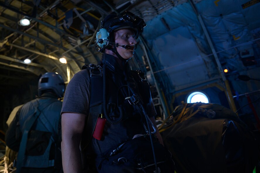 A pararescueman with the 31st Rescue Squadron prepares to jump out of a C-130 Hercules at Kadena Air Base, Japan, Aug. 27, 2014. The 31st RSQ worked with the 36th Airlift Squadron from Yokota Air Base, Japan, on currency, proficiency and upgrade training requirements. (U.S. Air Force photo by Tech. Sgt. Melissa K. Mekpongsatorn/Released)