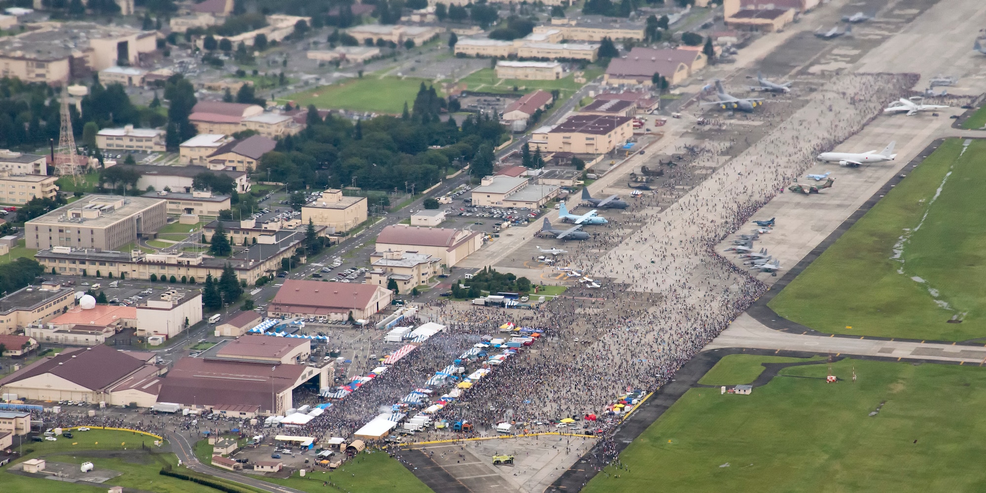 Thousands of visitors crowd the flightline during the Japanese-American Friendship Festival at Yokota Air Base, Japan, Sept. 6, 2014. Yokota welcomed approximately 148,000 visitors for the festival in two days. (U.S. Air Force photo by Senior Airman Michael Washburn/Released)